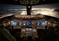 Interior of a glass cockpit with light orange lighting.