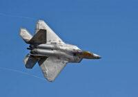 A fighter jet in flight against a backdrop of blue sky, demonstrating agility and strength in military aviation.